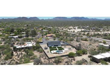 Beautiful aerial view of the property with a pool and manicured outdoor space amidst a desert landscape at 26626 N 70Th Pl, Scottsdale, AZ 85266