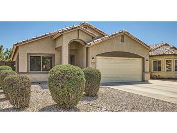 Charming home featuring a two-car garage, landscaped yard, and an inviting entryway at 2853 E Cathy Dr, Gilbert, AZ 85296