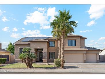Stunning two-story home featuring a spacious three-car garage, lush landscaping, and a welcoming front entrance at 3574 E Latham Way, Gilbert, AZ 85297