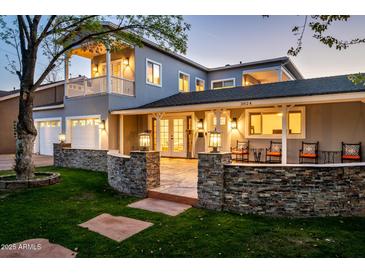 Elegant two-story home with stone accents, covered porch, well-lit with manicured lawn, and a warm inviting ambiance at 3824 N 50Th Pl, Phoenix, AZ 85018