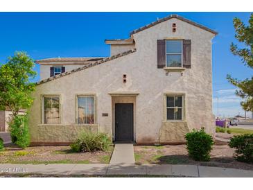 Charming two-story home featuring a desert-themed landscape and neutral color palette at 5104 W Fulton St, Phoenix, AZ 85043