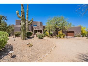 Expansive desert property featuring mature trees, large cacti, and a circular drive at 8606 E Arroyo Seco Rd, Scottsdale, AZ 85266