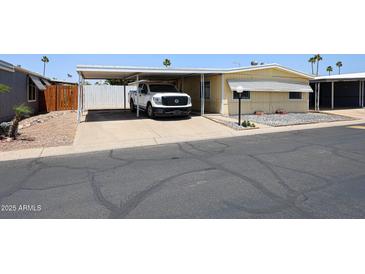 Charming home with covered parking and desert landscaping at 10951 N 91St Ave # 16, Peoria, AZ 85345