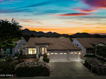 Charming single-story home with a tile roof, three-car garage, and desert landscaping set against a mountain backdrop at 14717 N 97Th Pl, Scottsdale, AZ 85260