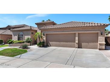 Charming home featuring a two-car garage and landscaped front yard in a sunny neighborhood at 1621 W Wildwood Dr, Phoenix, AZ 85045
