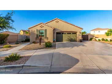 Charming single-story home with a well-maintained front yard and a two-car garage at 21084 E Cherrywood Dr, Queen Creek, AZ 85142