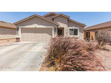 Charming single-story home with a two-car garage, desert landscaping, and a covered entryway at 22534 W Pima St, Buckeye, AZ 85326