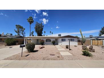 Charming single-story home with desert landscaping, walkway, and covered porch at 2548 E Encanto St, Mesa, AZ 85213