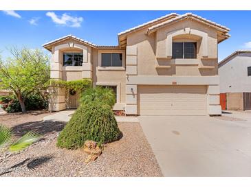 Inviting two-story home featuring a neutral color palette, well-kept landscaping, and attached two-car garage at 3786 S Chaparral Rd, Apache Junction, AZ 85119