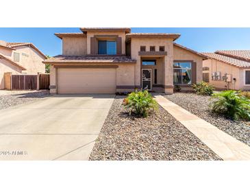 Charming two-story home featuring neutral stucco, manicured landscaping, and a two-car garage at 8555 W Purdue Ave, Peoria, AZ 85345