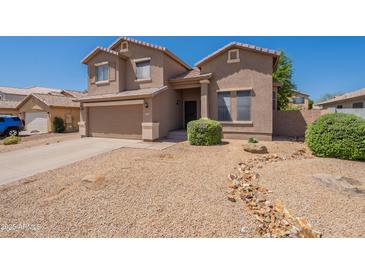 Two-story home features a well-kept yard, attached garage, and neutral-toned stucco exterior at 10228 E Carol Ave, Mesa, AZ 85208