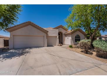 Charming single-story home featuring a three-car garage, neutral stucco, and low maintenance landscaping at 14771 W Columbus Ave, Goodyear, AZ 85395