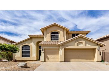 Inviting two-story home showcasing a well-manicured yard and attached two-car garage at 3132 E Wildwood Dr, Phoenix, AZ 85048