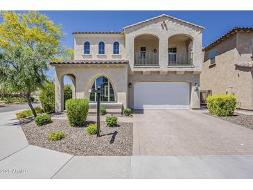 Charming two-story home with a balcony, arched windows and a well-manicured front yard at 3310 E Los Gatos Dr, Phoenix, AZ 85050