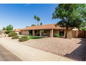 Charming single-story home featuring a tile roof, desert landscaping, and an inviting front porch at 410 E Beck Ln, Phoenix, AZ 85022