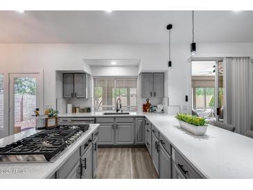 Bright kitchen with quartz countertops, stainless steel appliances, and a gas range cooktop at 8449 W Rockwood Dr, Peoria, AZ 85382