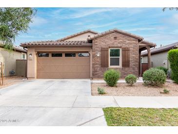 Charming single-story home boasts brick accents, a two-car garage, and desert landscaping for easy maintenance at 9831 E Tupelo Ave, Mesa, AZ 85212