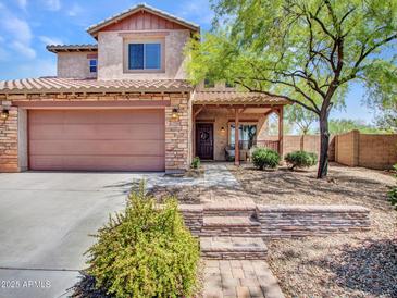 Charming two-story home features a covered front porch, desert landscaping, and a two-car garage at 12706 W Pasaro Dr, Peoria, AZ 85383
