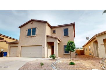 Inviting two-story home featuring a neutral color scheme, desert landscaping, and a convenient two-car garage at 16807 W Carmen Dr, Surprise, AZ 85388