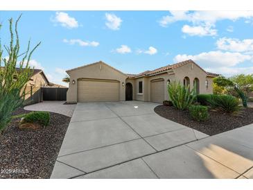 Charming home featuring a three-car garage, desert landscaping, and a tile roof at 27308 N 56Th Dr, Phoenix, AZ 85083