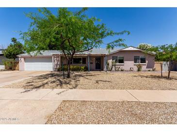 Charming single story home with desert landscaping and shade tree at 3030 E Shangri La Rd, Phoenix, AZ 85028