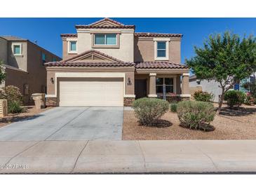 Charming two-story home featuring a two-car garage, neutral stucco, and a well-maintained front yard at 3113 N 303Rd Dr, Buckeye, AZ 85396