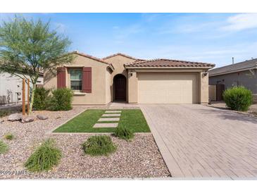Charming home featuring a two-car garage, desert landscaping, and a cozy, inviting entrance at 32567 N 133Rd Ave, Peoria, AZ 85383