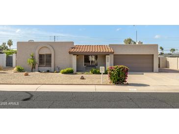 Charming single-story home featuring a well-maintained yard and covered entryway at 3821 W Woodridge Dr, Glendale, AZ 85308