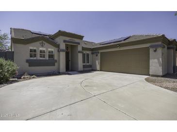 Inviting single-story home featuring a neutral color palette, a two-car garage, and well-maintained landscaping at 651 W Cobblestone Dr, Casa Grande, AZ 85122