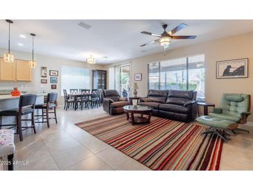 Open-concept living room with tile flooring, neutral tones, and plenty of natural light at 102 W Raven Dr, Chandler, AZ 85286