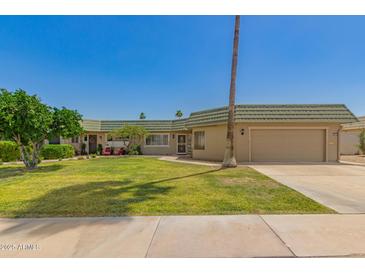 Charming single-story home with lush green lawn and attached two-car garage at 10505 W Campana Dr, Sun City, AZ 85351