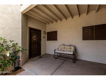 Charming front porch with seating, creating a welcoming entrance to the home at 11375 E Sahuaro Dr # 1062, Scottsdale, AZ 85259