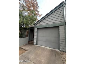 Two-story home featuring gray siding and a two-car garage with a driveway, showcasing curb appeal at 14002 N 49Th Ave # 1120, Glendale, AZ 85306