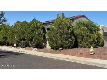 Street view of a well-maintained home with mature landscaping and a classic fire hydrant at 1402 E Wescott Dr, Phoenix, AZ 85024