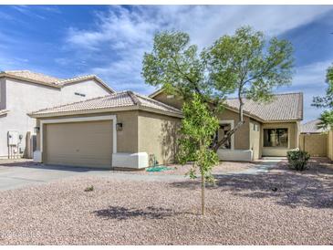 Inviting single-Gathering home featuring a neutral color palette, desert landscaping, and an attached two car garage at 15067 W Taylor St, Goodyear, AZ 85338