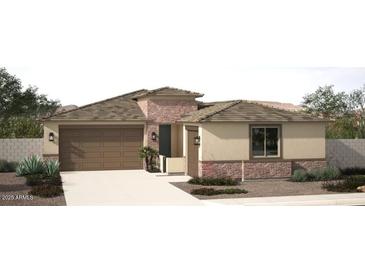 Charming single-story home featuring a two-car garage, desert landscaping, and a stone-accented facade at 18063 W Larkspur Dr, Goodyear, AZ 85338
