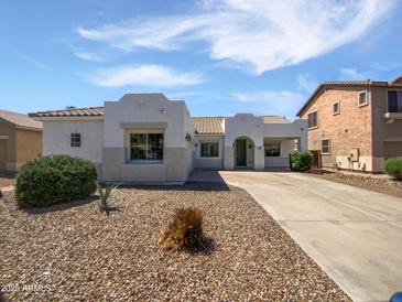 Charming single-story home with a well-maintained front yard and a welcoming entrance at 19973 E Thornton Rd, Queen Creek, AZ 85142