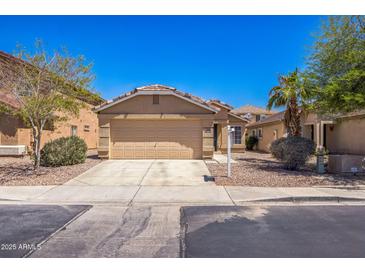 Charming single-story home with a two-car garage, desert landscaping, and a well-maintained front yard at 22010 W Solano Dr, Buckeye, AZ 85326