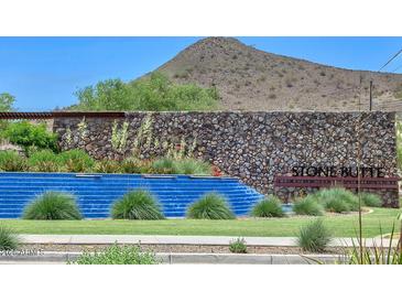 Stone Butte community waterfall with lush greenery and stone accents; a serene neighborhood entrance at 24314 N 21St Pl, Phoenix, AZ 85024