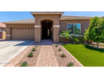 Charming single-story home featuring a low-maintenance front yard with vibrant artificial turf and desert landscaping at 3081 E Desert Broom Pl, Chandler, AZ 85286