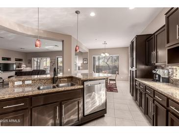Well-equipped kitchen features stainless steel appliances, granite countertops, and a stylish breakfast bar at 41638 N Emerald Lake Dr, Anthem, AZ 85086