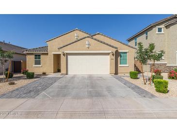 Charming single-story home featuring a well-manicured yard and a two-car garage at 4514 W Hazel Ln, San Tan Valley, AZ 85144