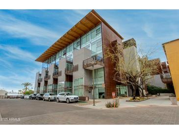 Contemporary condo building featuring copper and concrete facade, complemented by modern architectural design at 4747 N Scottsdale Rd # 4009, Scottsdale, AZ 85251