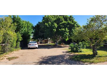 Spacious driveway with mature trees providing ample shade and parking at 8527 W Jefferson St, Peoria, AZ 85345