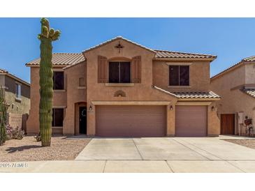 Two-story home featuring a tile roof, two-car garage, and desert landscaping at 18903 N Shelby Dr, Maricopa, AZ 85138