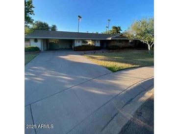 Charming single-story home with a spacious driveway and well-maintained front yard at 3144 N 84Th Pl, Scottsdale, AZ 85251