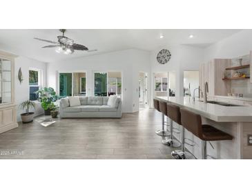 Open-concept kitchen with a breakfast bar, stainless steel appliances, and a view into the living area at 4073 E Stable Ct, Gilbert, AZ 85297