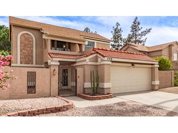 Two-story home featuring a red tile roof, stucco exterior, and well-kept landscaping at 529 E Taro Ln, Phoenix, AZ 85024