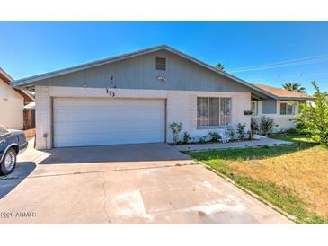 Charming single-story home featuring a two-car garage and quaint landscaping at 133 W Balboa Dr, Tempe, AZ 85282