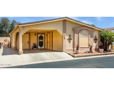 Charming single-story home featuring covered parking, desert landscaping, and textured stucco facade at 1640 E Augusta Ave, Chandler, AZ 85249